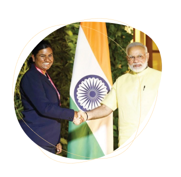 Photograph of Tracy, our sports physiotherapist, alongside Indian Prime Minister Narendra Modi